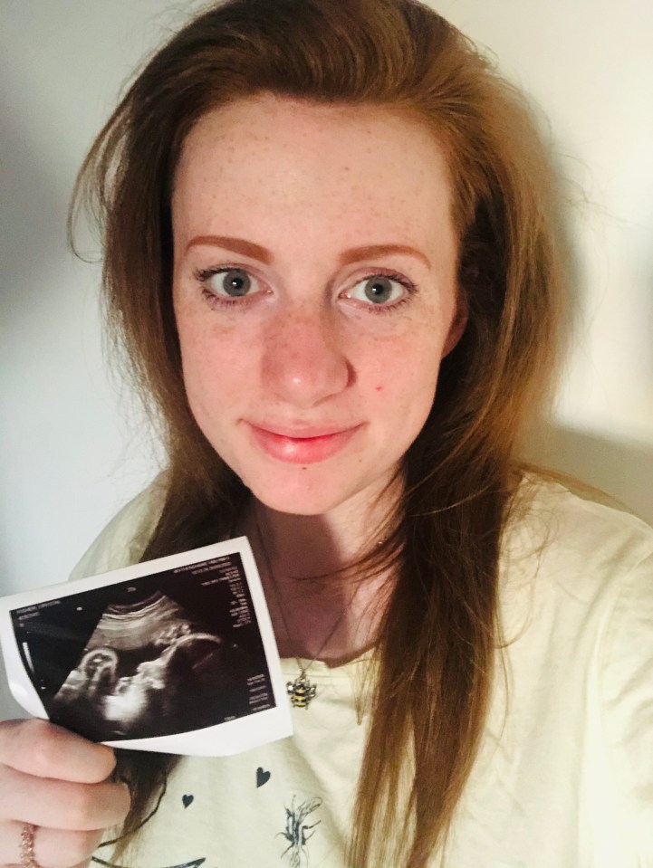 a woman holds a picture of a baby in her hand