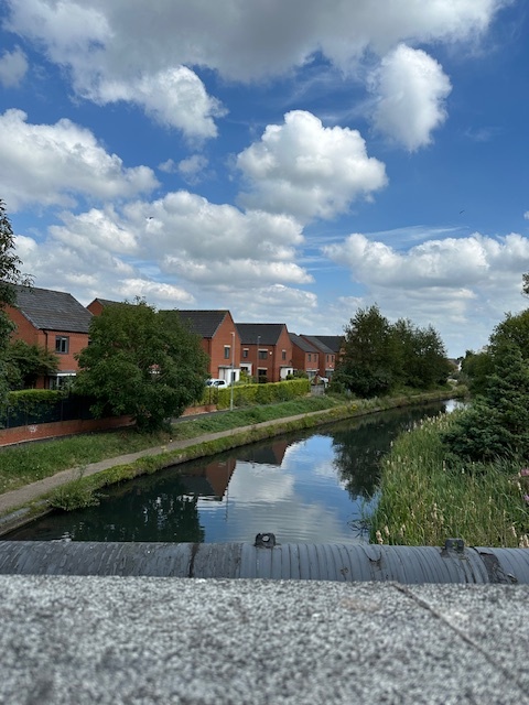 a row of houses next to a river on a sunny day