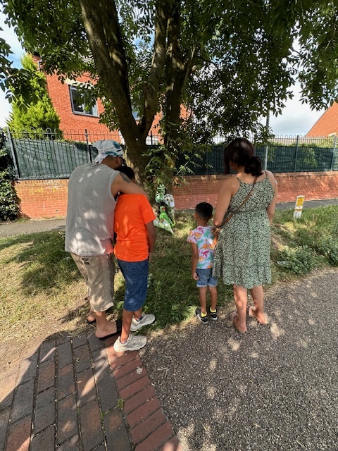 a group of people looking at a tree with flowers on it