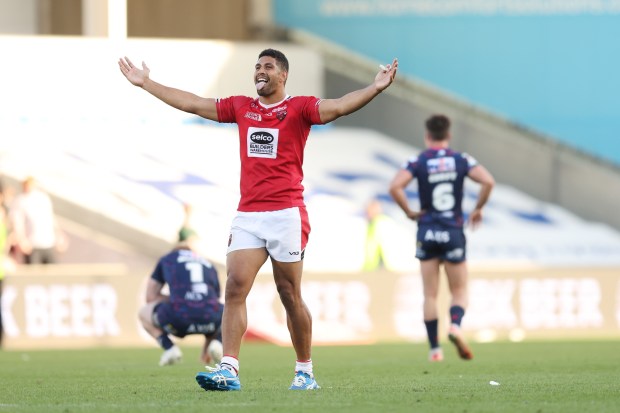 a rugby player wearing a red shirt with the word unco on it