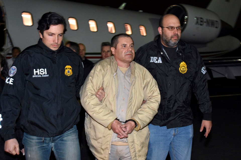 FILE - Authorities escort Joaquin "El Chapo" Guzman from a plane to a waiting caravan of SUVs at Long Island MacArthur Airport, in Ronkonkoma, N.Y., Jan. 19, 2017. (U.S. law enforcement via AP, File)