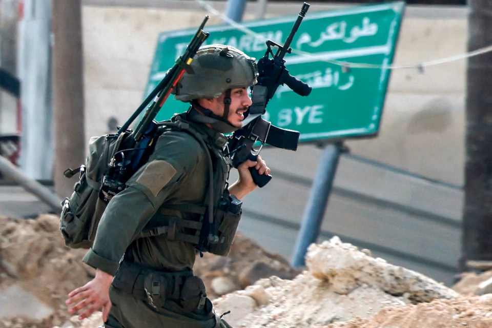 An Israeli soldier takes position during an army operation in Tulkarm in the north of the occupied West Bank on August 29, 2024. Israel on August 28 launched a large-scale operation in the occupied West Bank where the military said it killed Palestinian fighters, as the nearly 11-month-old Gaza war showed no signs of abating. (Photo by Jaafar ASHTIYEH / AFP) (Photo by JAAFAR ASHTIYEH/AFP via Getty Images)