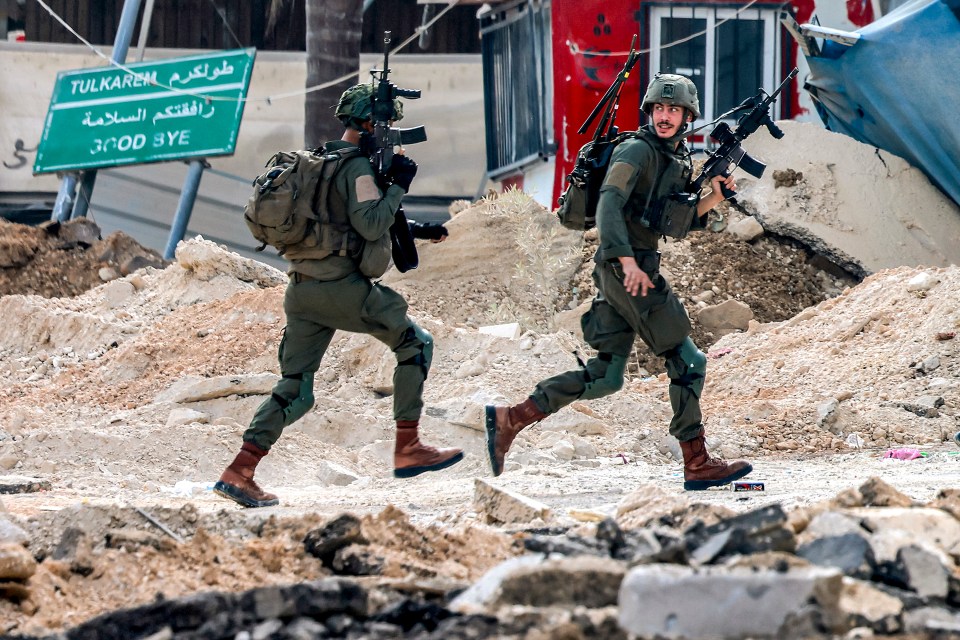 Israeli soldiers take position during an army operation in Tulkarm in the north of the occupied West Bank on August 29, 2024. Israel on August 28 launched a large-scale operation in the occupied West Bank where the military said it killed Palestinian fighters, as the nearly 11-month-old Gaza war showed no signs of abating. (Photo by Jaafar ASHTIYEH / AFP) (Photo by JAAFAR ASHTIYEH/AFP via Getty Images)