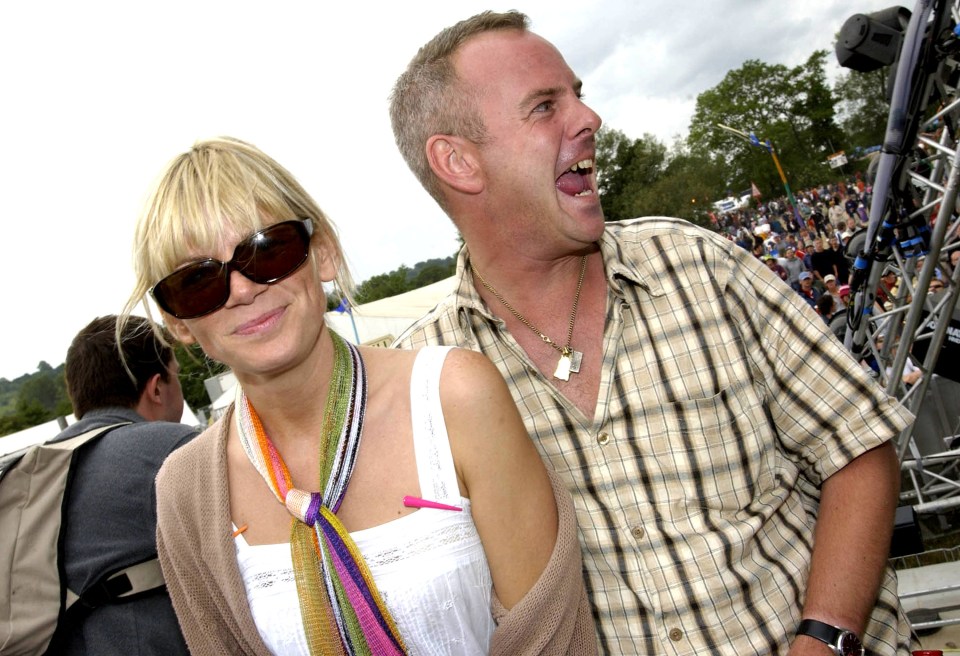 a man and a woman are standing next to each other and the man is sticking his tongue out