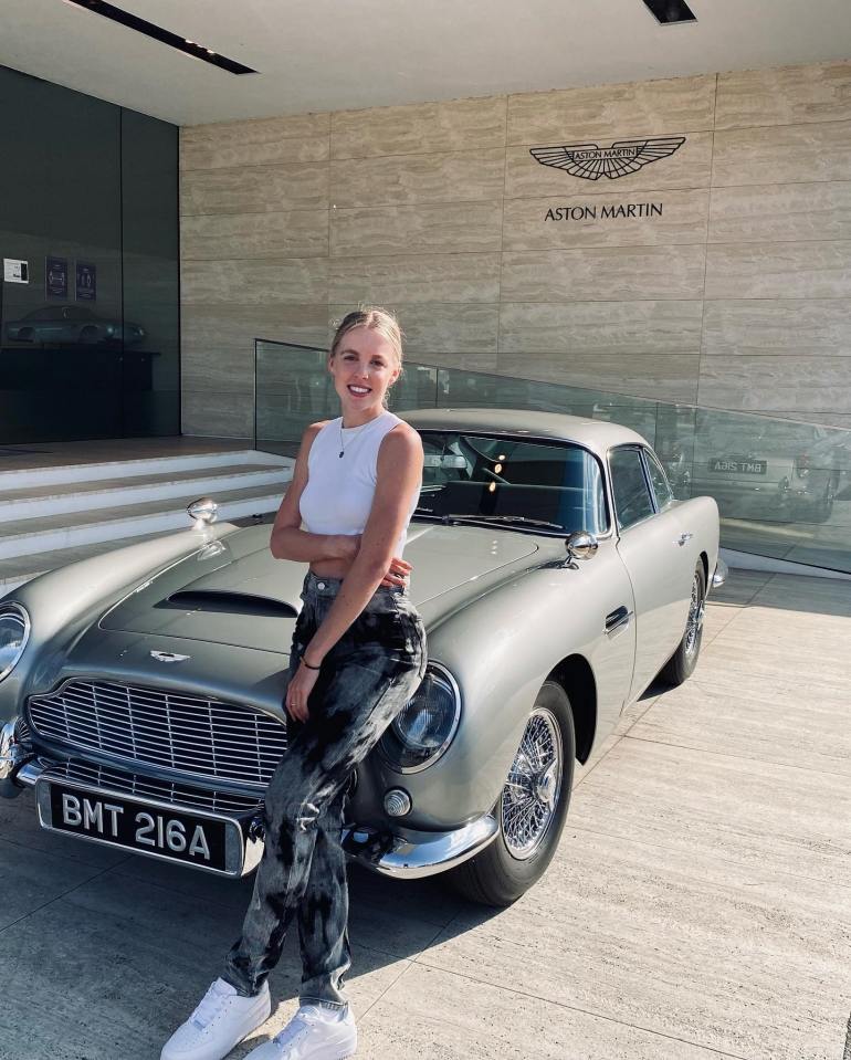 Keely poses with a vintage Aston Martin