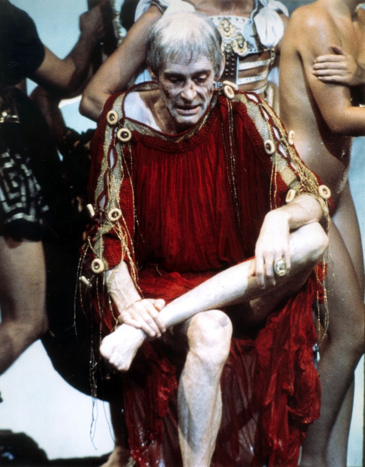 a man in a red and gold outfit is kneeling down