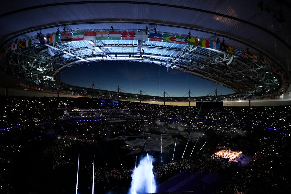 a stadium filled with people and flags with one that says ' russia ' on it