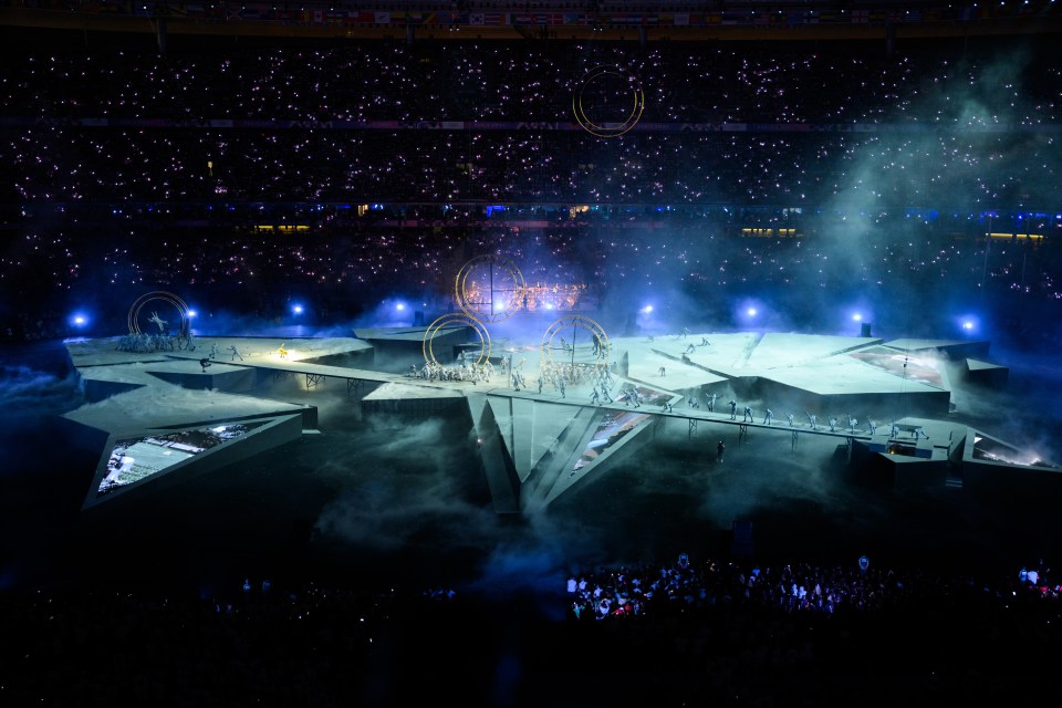 a large stadium with a lot of lights and smoke