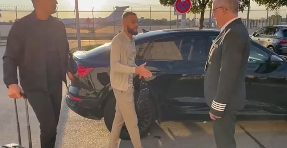 a man is getting out of a car and talking to a pilot .