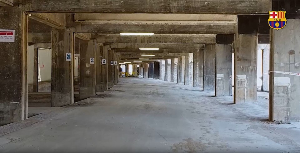 a very long hallway with a fcb logo on the wall