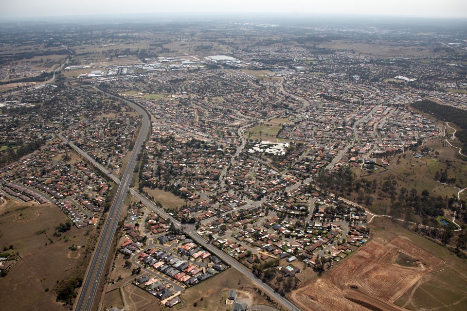 an aerial view of a residential area with a highway going through it