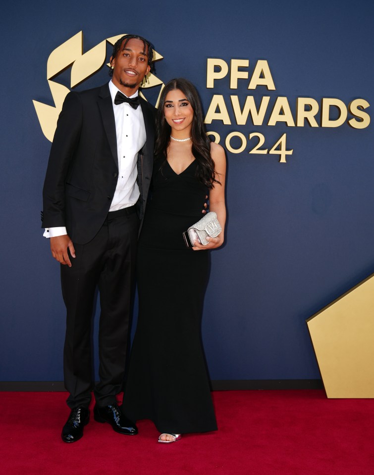 a man and a woman pose on the red carpet at the pfa awards