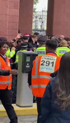 The group of away supporters were being held up outside the Shed End