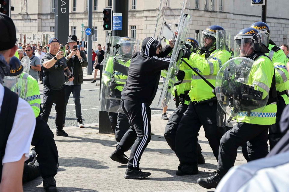 Masked thugs clash with riot cops in Liverpool