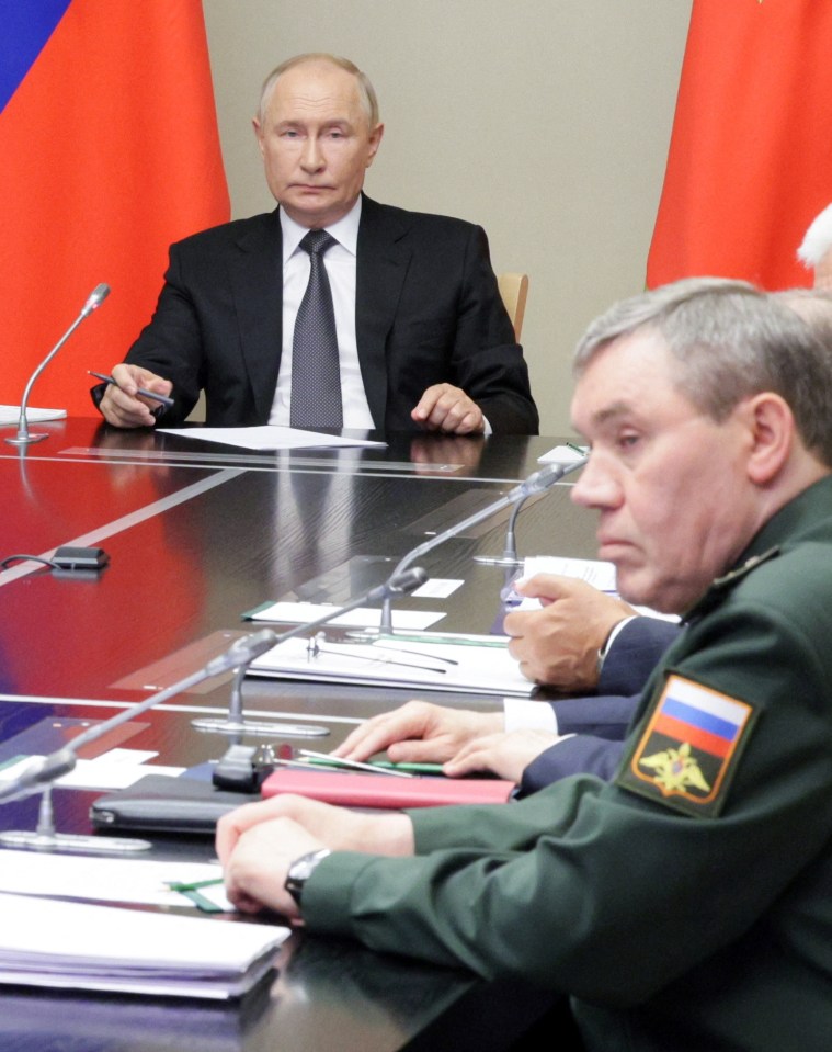 Putin looks towards Chief of the General Staff of Russian Armed Forces Valery Gerasimov, who he's said to be infuriated with