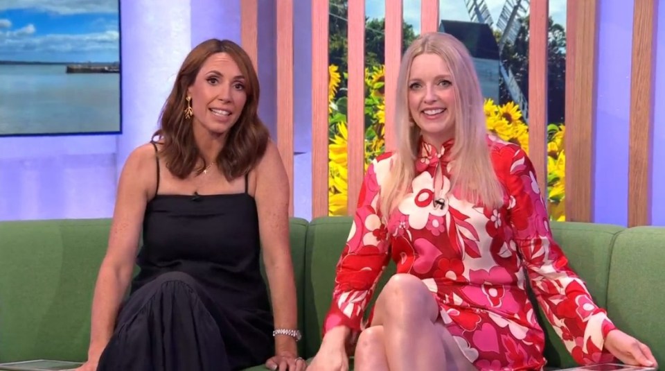 two women sit on a green couch with their legs crossed