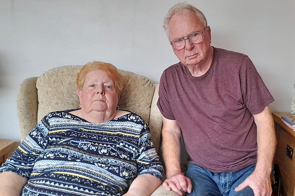 a man and a woman are sitting next to each other in a chair