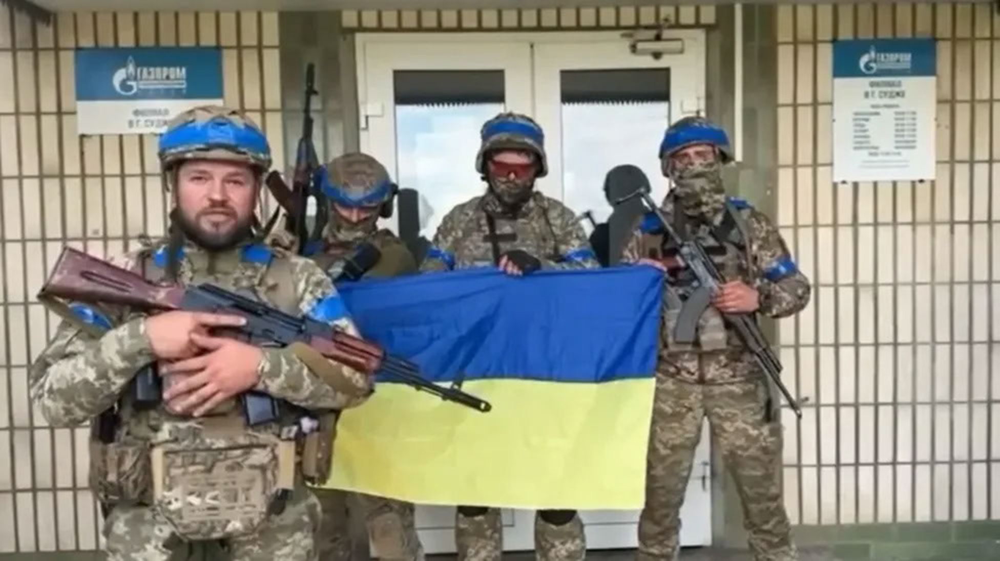 Ukrainian soldiers display their flag at a Gazprom gas facility in Sudzha