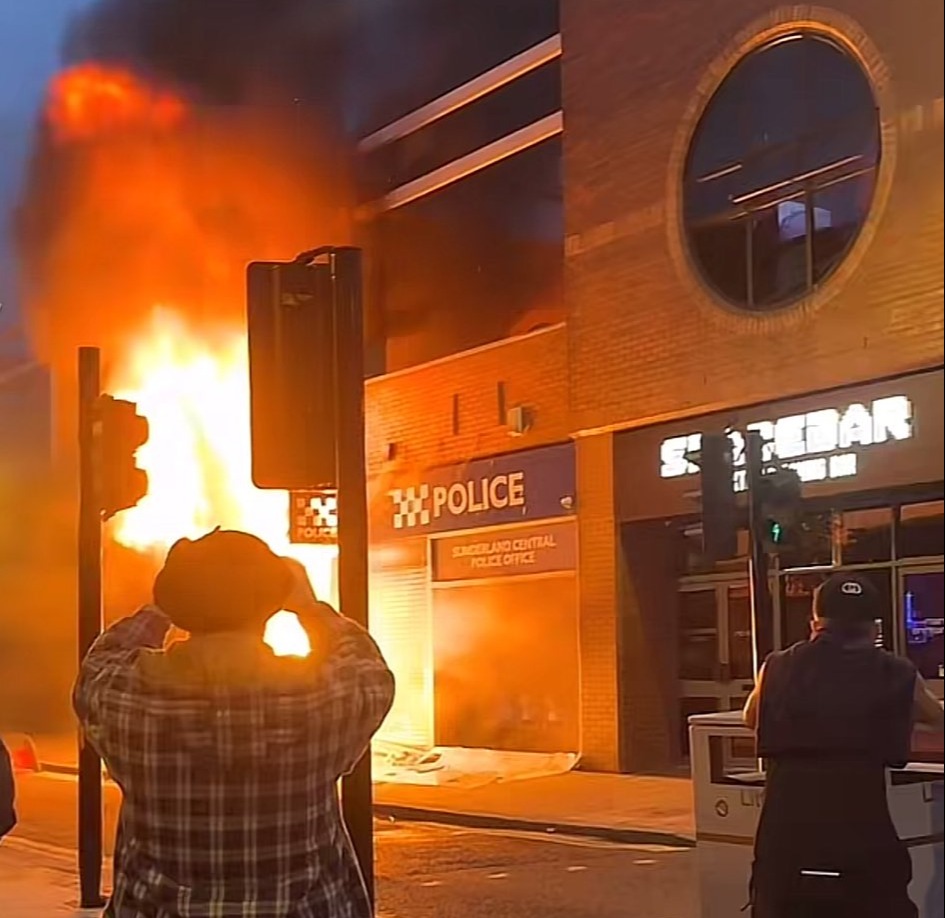 Crowds watched on as thugs looted a burning police station in Sunderland