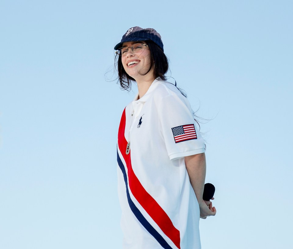 a woman wearing a polo shirt with an american flag on it