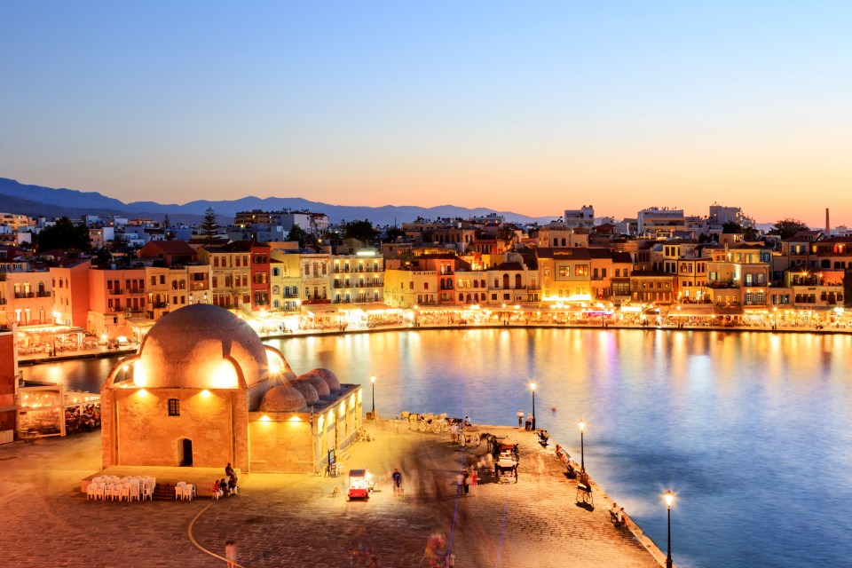 a large body of water with a city in the background