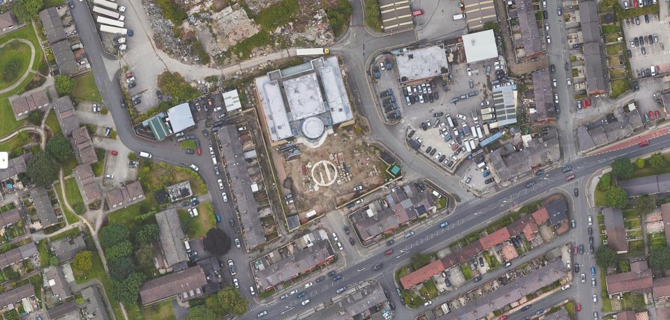 an aerial view of a residential area with a large building in the middle