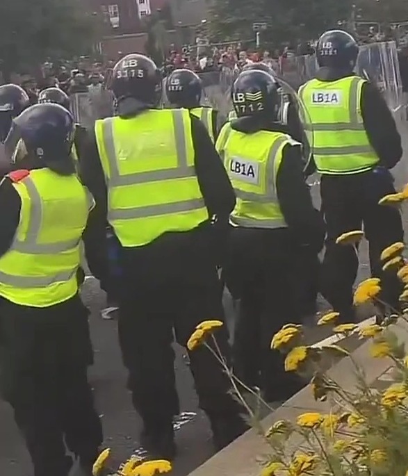 Cops were pelted with bricks as they bravely held their ground