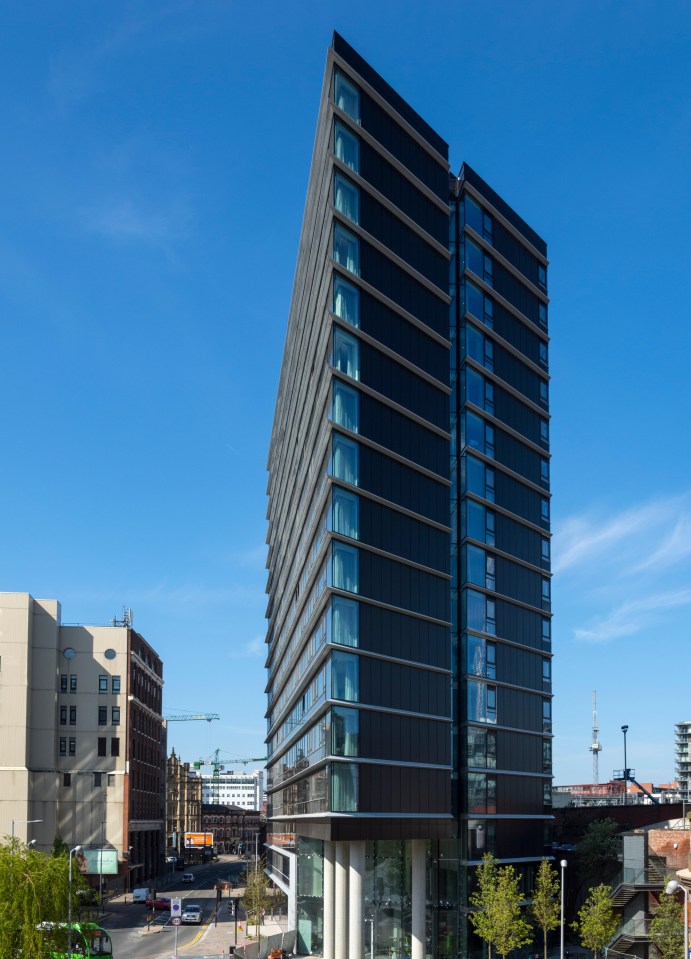 a large building with a sign that says ' no parking ' on it