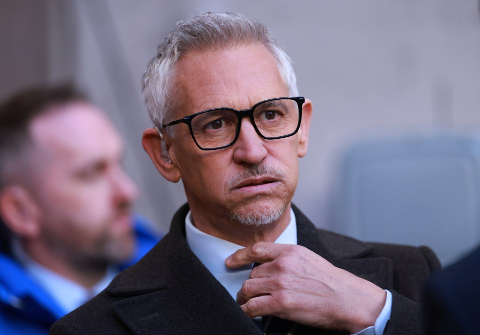 a man with glasses and a beard adjusts his tie