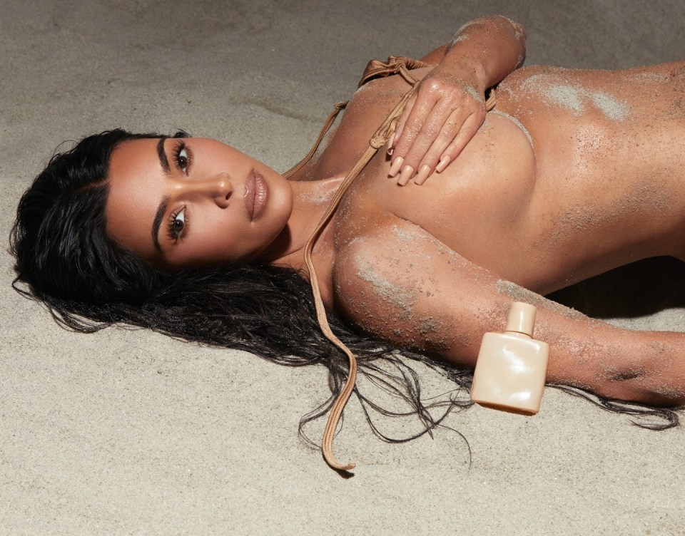 Kim went topless after stripping off in a nude bikini top during a sandy beach shoot