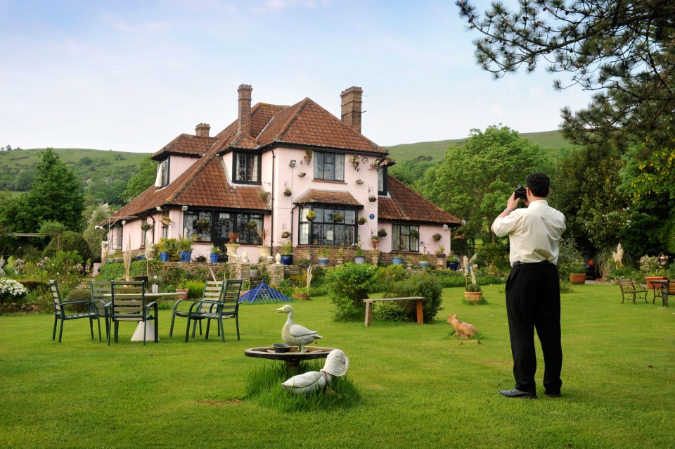 a man taking a picture of a house with a camera