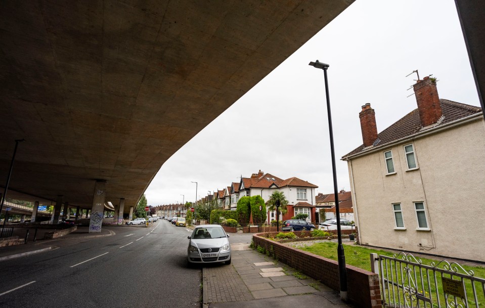 a white car is parked underneath a bridge