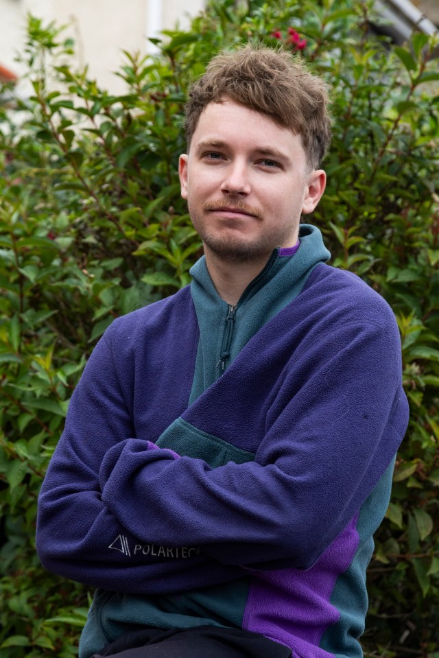 a man with his arms crossed wearing a polartec sweatshirt