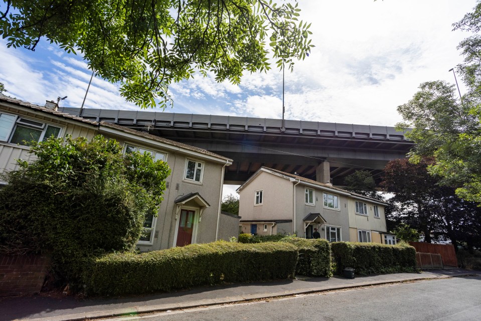 a row of houses under a bridge on a sunny day