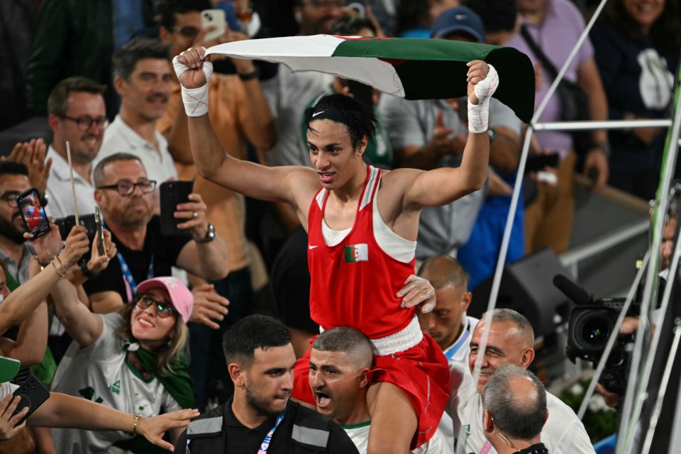 The victorious star raises her country's flag aloft