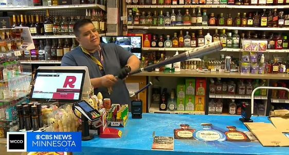 The girl's dad, Leo, shows the baseball bat his daughter used to save him