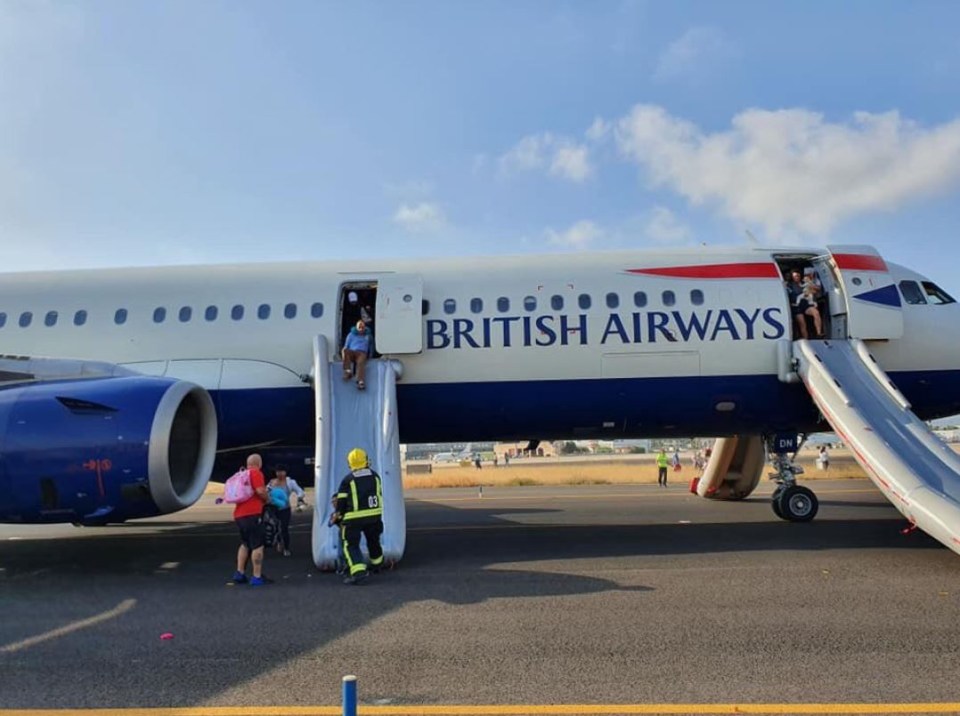 people boarding a british airways plane on a runway