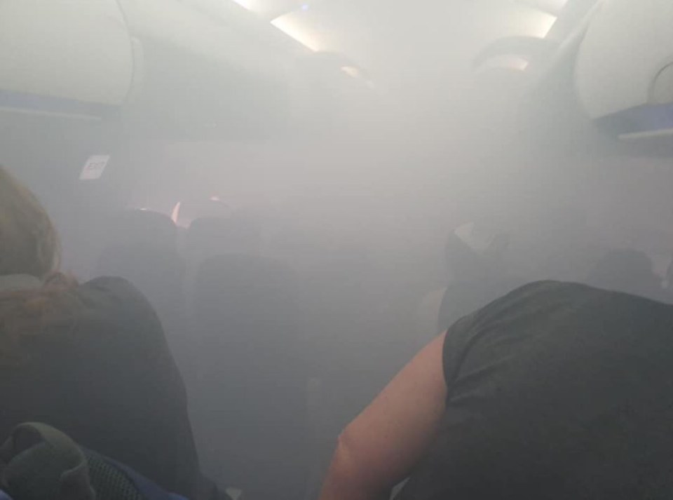 smoke coming out of the ceiling of an airplane