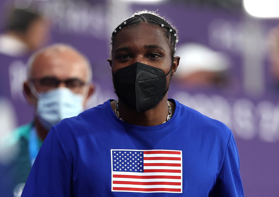 a woman wearing a blue shirt with an american flag on it