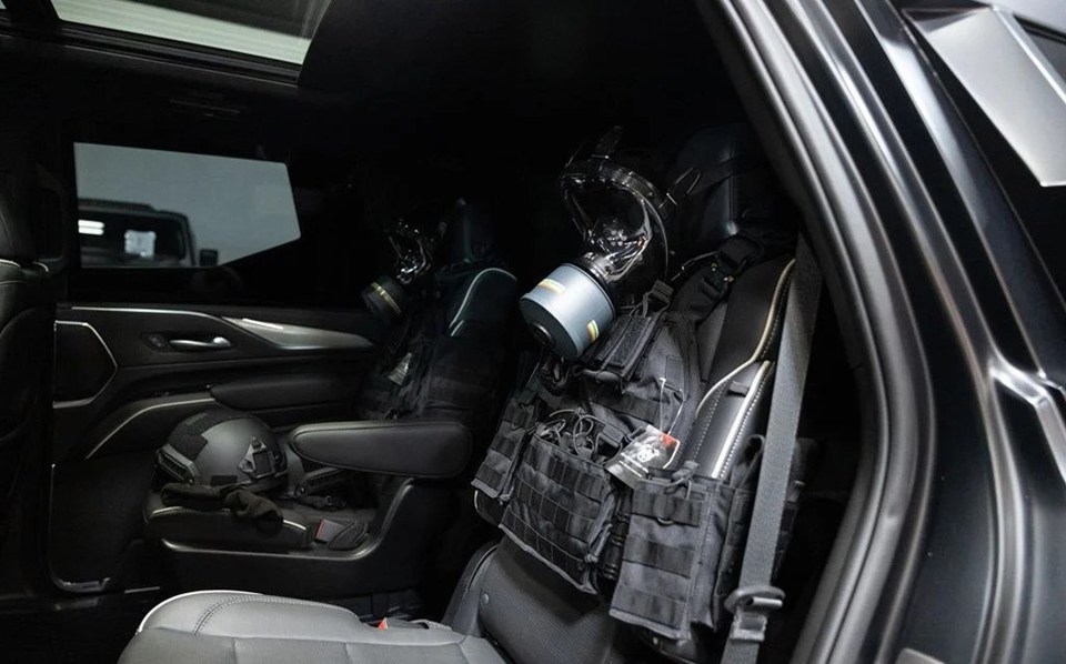 a gas mask is hanging from the back seat of a car