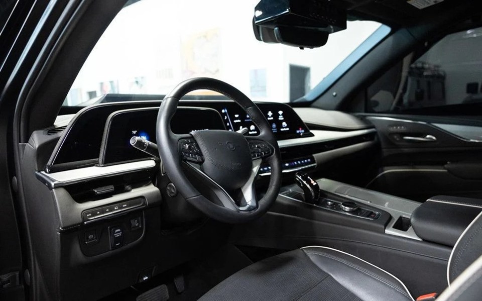 the inside of a car with a steering wheel and dashboard