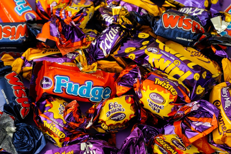 a pile of cadbury candy including fudge and twisted