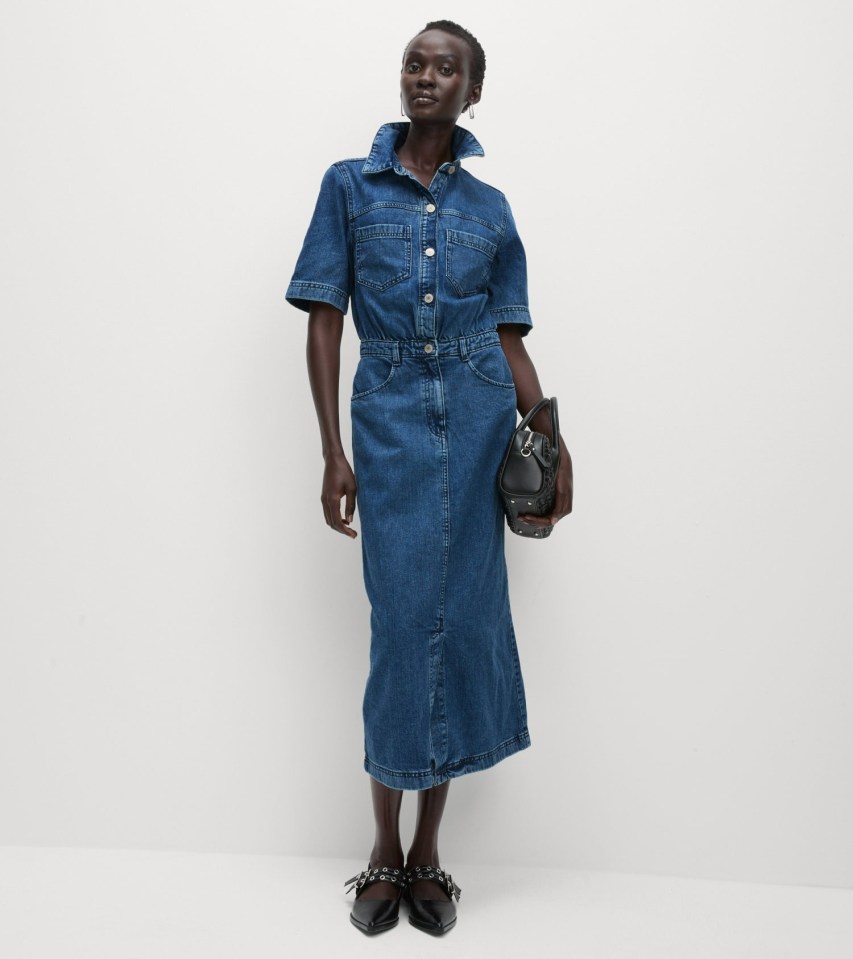 a woman is wearing a blue denim dress and black shoes