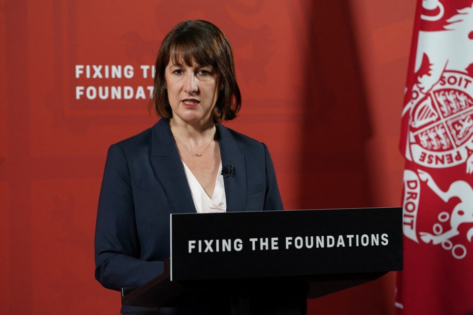 a woman stands behind a podium that says fixing the foundations