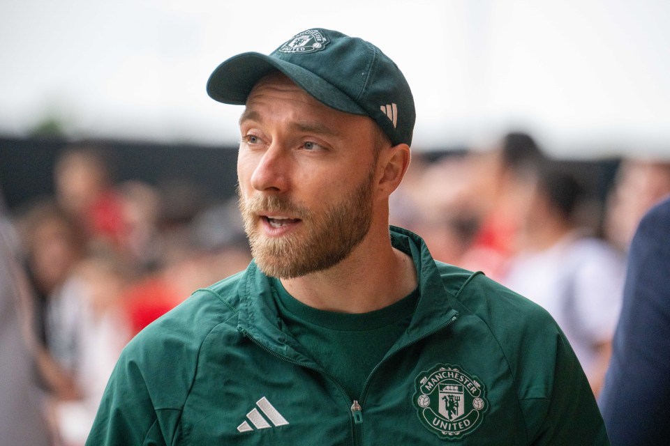 a man wearing a green manchester united jacket