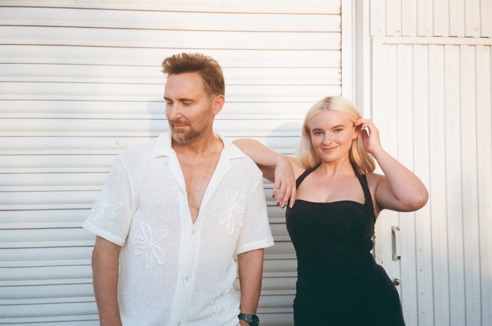 a man in a white shirt and a woman in a black dress are standing next to each other