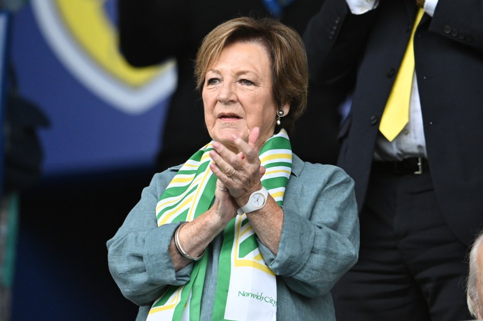 a woman wearing a green and yellow scarf that says nantucket city