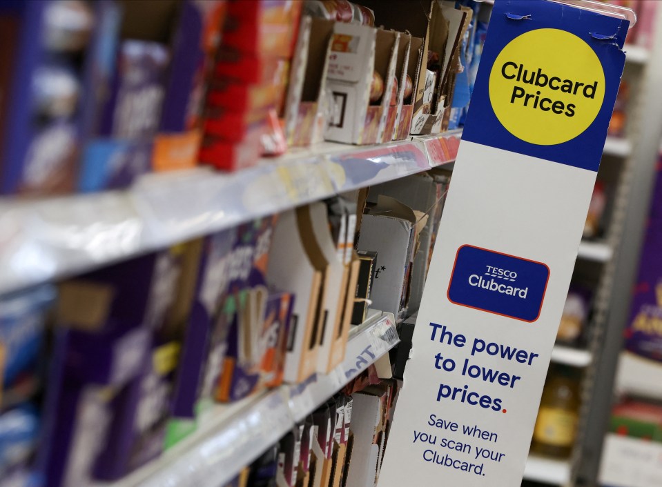 a tesco clubcard sign hangs on a store shelf