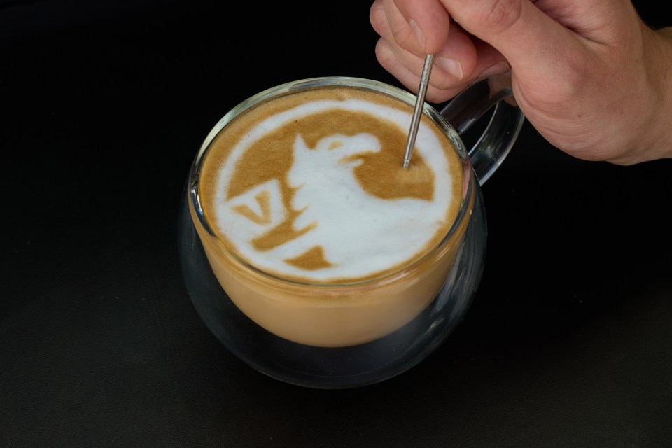 a cup of coffee with a unicorn design on the foam