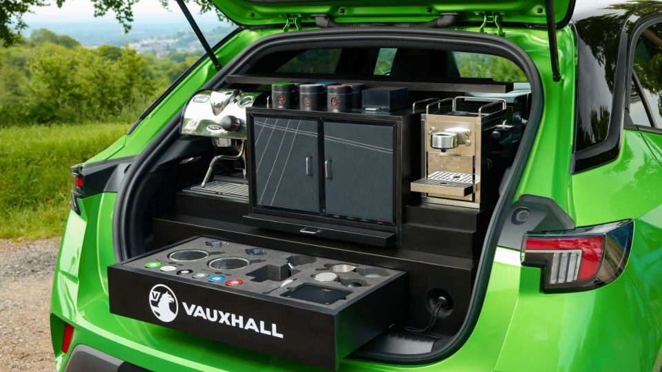 a green vauxhall car has a coffee machine in the back